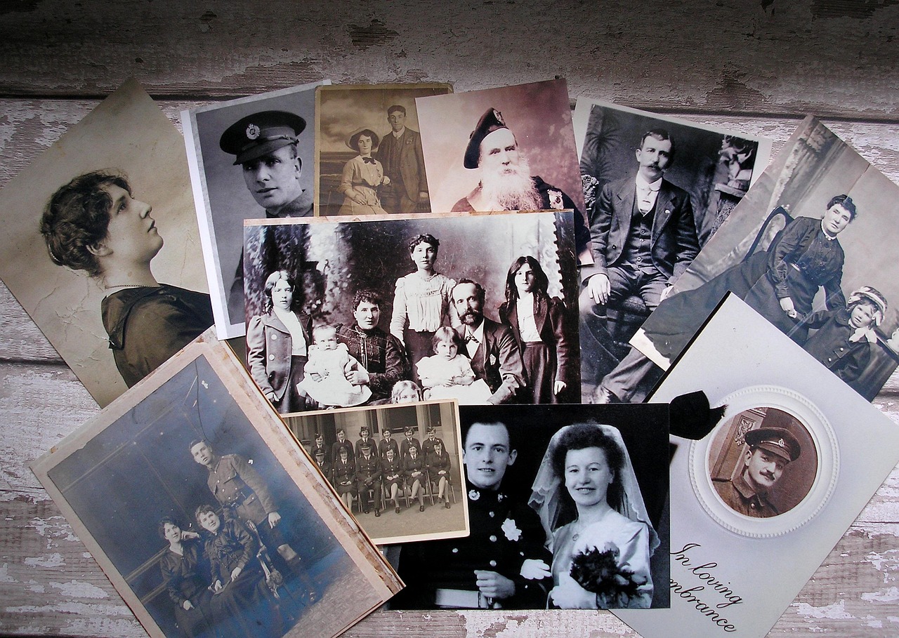 Vintage family photographs and portraits spread across a weathered wooden surface